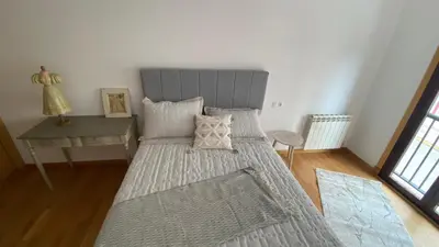 a bedroom with a large bed and a desk at Casa Sanjurjo in Monforte de Lemos