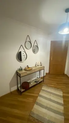 a room with a table with three mirrors on the wall at Casa Sanjurjo in Monforte de Lemos