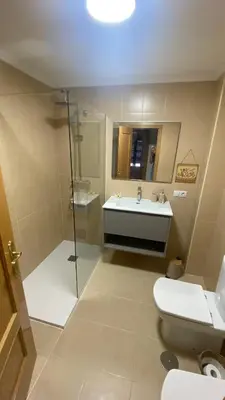 a bathroom with a toilet and a sink and a shower at Casa Sanjurjo in Monforte de Lemos