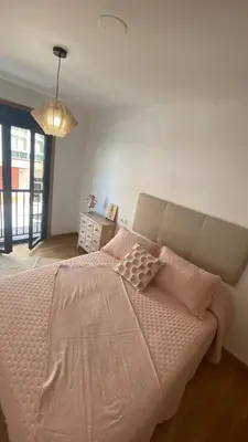 a bedroom with a large bed with pink pillows at Casa Sanjurjo in Monforte de Lemos