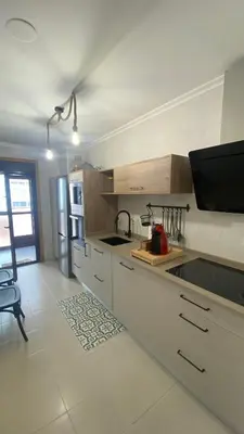 a kitchen with white cabinets and a refrigerator at Casa Sanjurjo in Monforte de Lemos