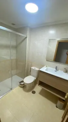a bathroom with a toilet and a sink and a shower at Casa Sanjurjo in Monforte de Lemos