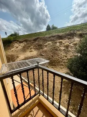 a bed on top of a balcony with a hill at RAXEL - MIÑO in Miño