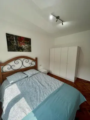 a bedroom with a bed and a painting on the wall at RAXEL - MIÑO in Miño