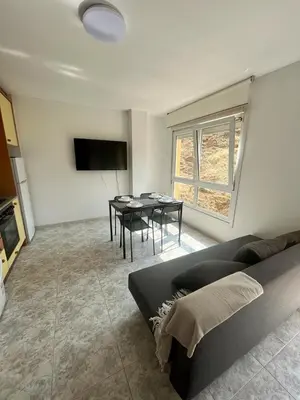 a living room with a couch and a dining room at RAXEL - MIÑO in Miño