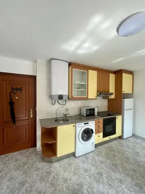 a kitchen with a washing machine and a washer at RAXEL - MIÑO in Miño