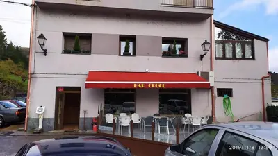 a building with a restaurant with a red awning at El Cruce 1 y 2 in Villafranca del Bierzo
