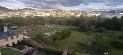 an aerial view of an old building and a city at El Cruce 1 y 2 in Villafranca del Bierzo