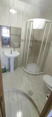a bathroom with a shower and a toilet and a sink at El Cruce 1 y 2 in Villafranca del Bierzo