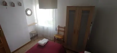 a bedroom with a bed and a window and a clock at El Cruce 1 y 2 in Villafranca del Bierzo