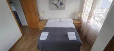 a small bedroom with a bed and two night stands at El Cruce 1 y 2 in Villafranca del Bierzo