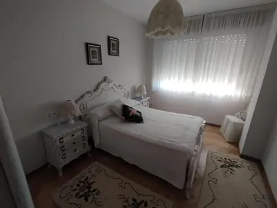 a bedroom with a white bed and a window at PISO MANCE in Allariz