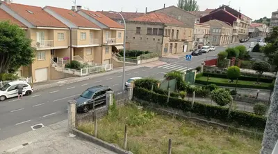 a view of a city street with houses and cars at PISO MANCE in Allariz