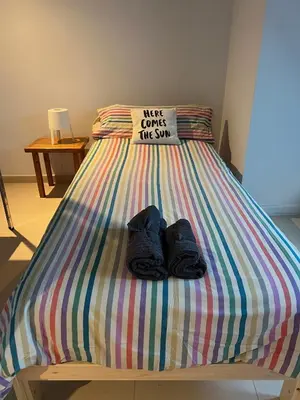 a bed with a pair of shoes sitting on it at Ático Camino Santiago: El Comienzo Perfecto in Sarria