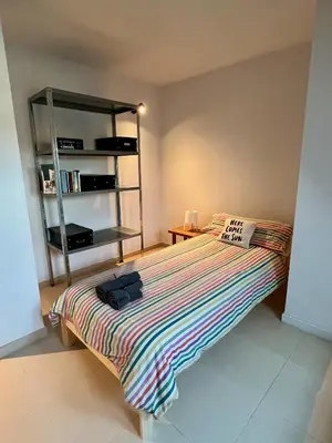 a bedroom with a bed with a book shelf at Ático Camino Santiago: El Comienzo Perfecto in Sarria