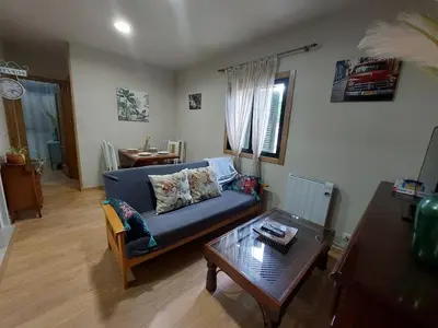 a living room with a blue couch and a table at FOGAR CAÑÓN DO SIL - En la Ribeira Sacra in Nogueira de Ramuin