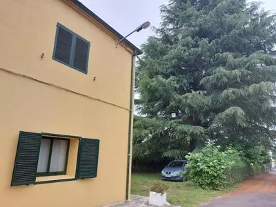 a car parked next to a house with a tree at FOGAR CAÑÓN DO SIL - En la Ribeira Sacra in Nogueira de Ramuin