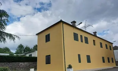 a yellow building with a roof on top of it at FOGAR CAÑÓN DO SIL - En la Ribeira Sacra in Nogueira de Ramuin