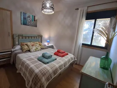 a bedroom with a bed with pillows on it at FOGAR CAÑÓN DO SIL - En la Ribeira Sacra in Nogueira de Ramuin