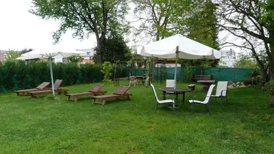 a group of tables and chairs with an umbrella at Pensión Albergue A Pedra in Sarria