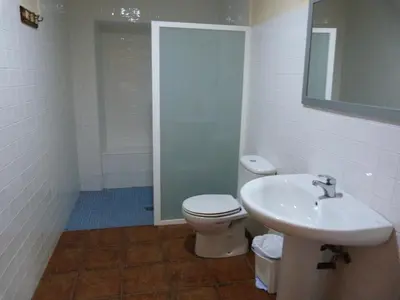 a bathroom with a toilet and a sink at Pensión Albergue A Pedra in Sarria