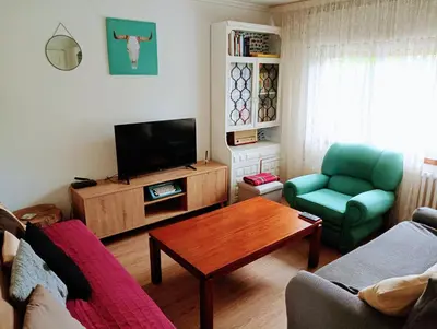 a living room with a couch and a table at Casa campo con piscina La Arboleda in Amoeiro