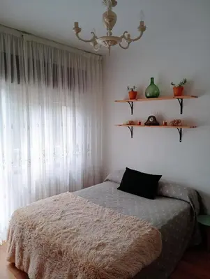 a bedroom with a bed and a chandelier at Casa campo con piscina La Arboleda in Amoeiro