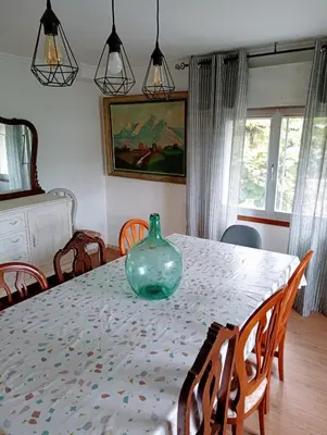 a dining room table with a vase on top of it at Casa campo con piscina La Arboleda in Amoeiro