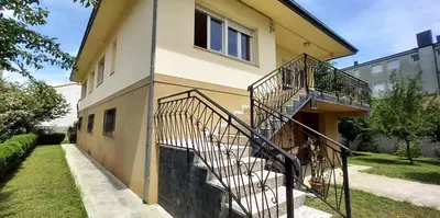 a house with a spiral staircase on the side of it at Casa Matilde de Melide in Melide