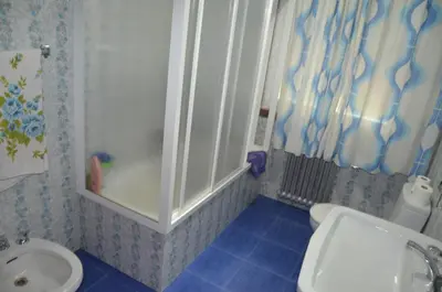 a bathroom with a tub and a toilet and a sink at Casa Matilde de Melide in Melide