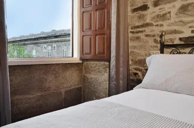 a bedroom with a bed and a window at Sete Artes by Como en Casa in Santiago de Compostela