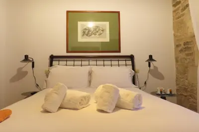 a bedroom with a bed with three towels on it at Sete Artes by Como en Casa in Santiago de Compostela