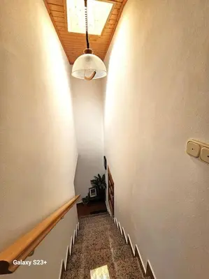 a hallway with a staircase with a light and a ceiling at Casa Lina VUT OR 000784 in Allariz