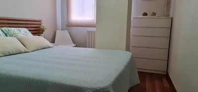 a bedroom with a bed with a dresser and a window at Estudio céntrico con terraza in Xinzo de Limia
