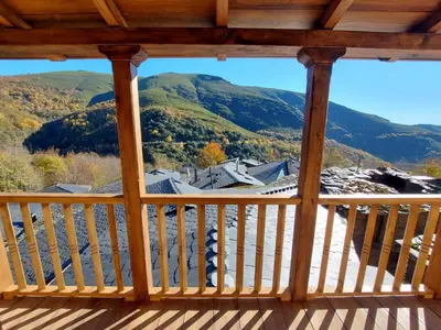 a view from the deck of a cabin with mountains at Lar da cima in Folgoso