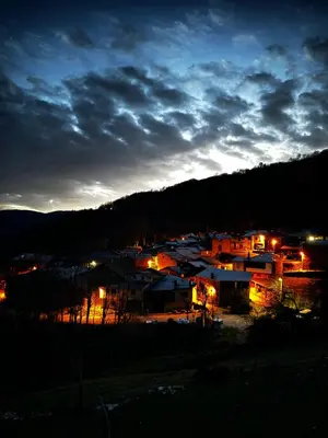 a view of a town at night with lights at A Barreira -Lar da cima- in Folgoso