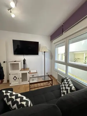 a living room with a couch and a flat screen tv at Piso da Ulla in A Estrada