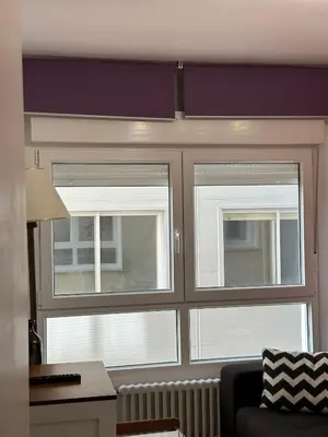 a living room with three windows and a couch at Piso da Ulla in A Estrada