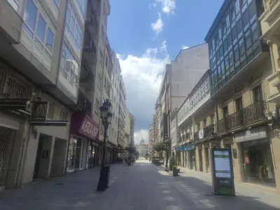 an empty street in a city with tall buildings at Piso da Ulla in A Estrada