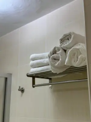 a pile of towels on a towel rack in a bathroom at Piso da Ulla in A Estrada