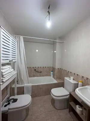 a bathroom with a tub and a toilet and a sink at Suite Rigel in Ponferrada