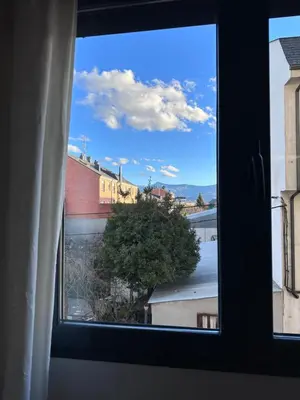 a window with a view of a river and buildings at Suite Rigel in Ponferrada