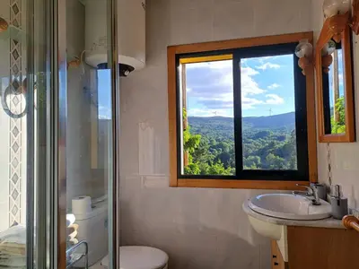 a bathroom with a shower and a sink and a window at Ás Portas do Sil - En la Ribeira Sacra in Villar de Cerreda