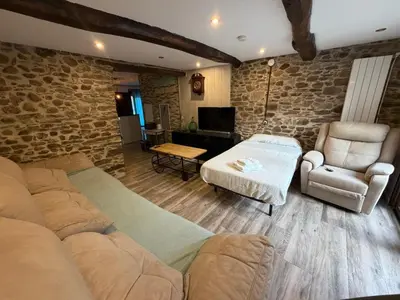 a living room with a couch and a chair at Villa de la paz Ribeira Sacra in Monforte de Lemos