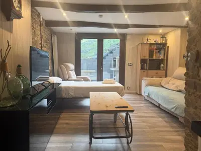a room with two beds and a table in it at Villa de la paz Ribeira Sacra in Monforte de Lemos