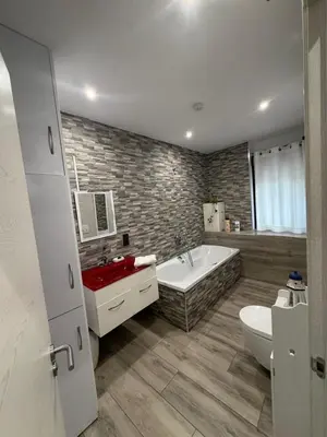 a bathroom with a tub and a sink and a toilet at Villa de la paz Ribeira Sacra in Monforte de Lemos