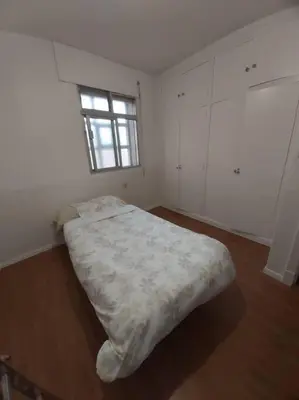 a bedroom with a bed in a room with a window at Casa Ricardo (16km de Coruña) in Castro