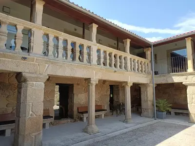 an external view of a house with a balcony at Casa das Capelas in Villamarín