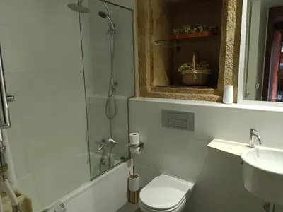 a bathroom with a shower and a toilet and a sink at Casa das Capelas in Villamarín
