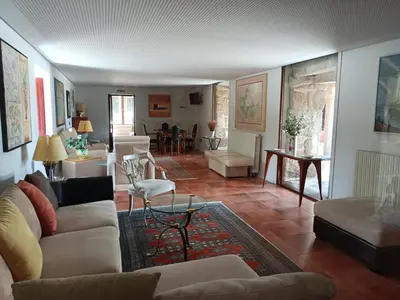 a living room with white couches and a dining room at Casa das Capelas in Villamarín